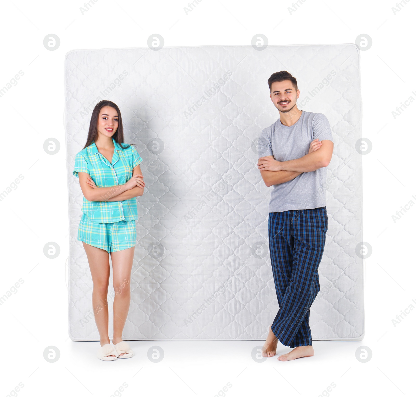 Photo of Young couple with comfortable mattress isolated on white