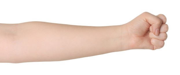 Photo of Playing rock, paper and scissors. Woman showing fist on white background, closeup