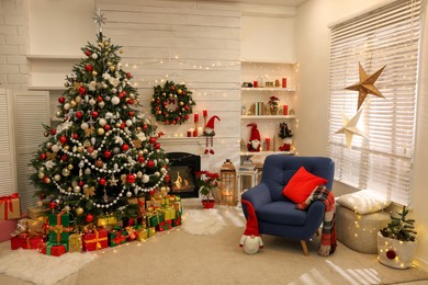 Decorated Christmas tree with gift boxes and fireplace in stylish living room interior