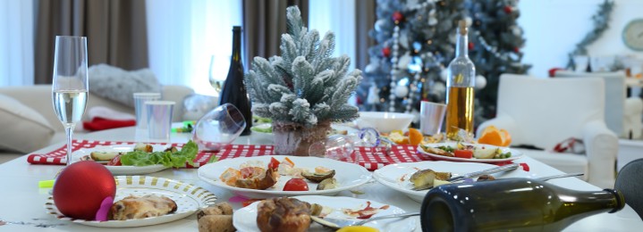 Image of Dirty dishes on white table in room. Mess after new year party. Banner design