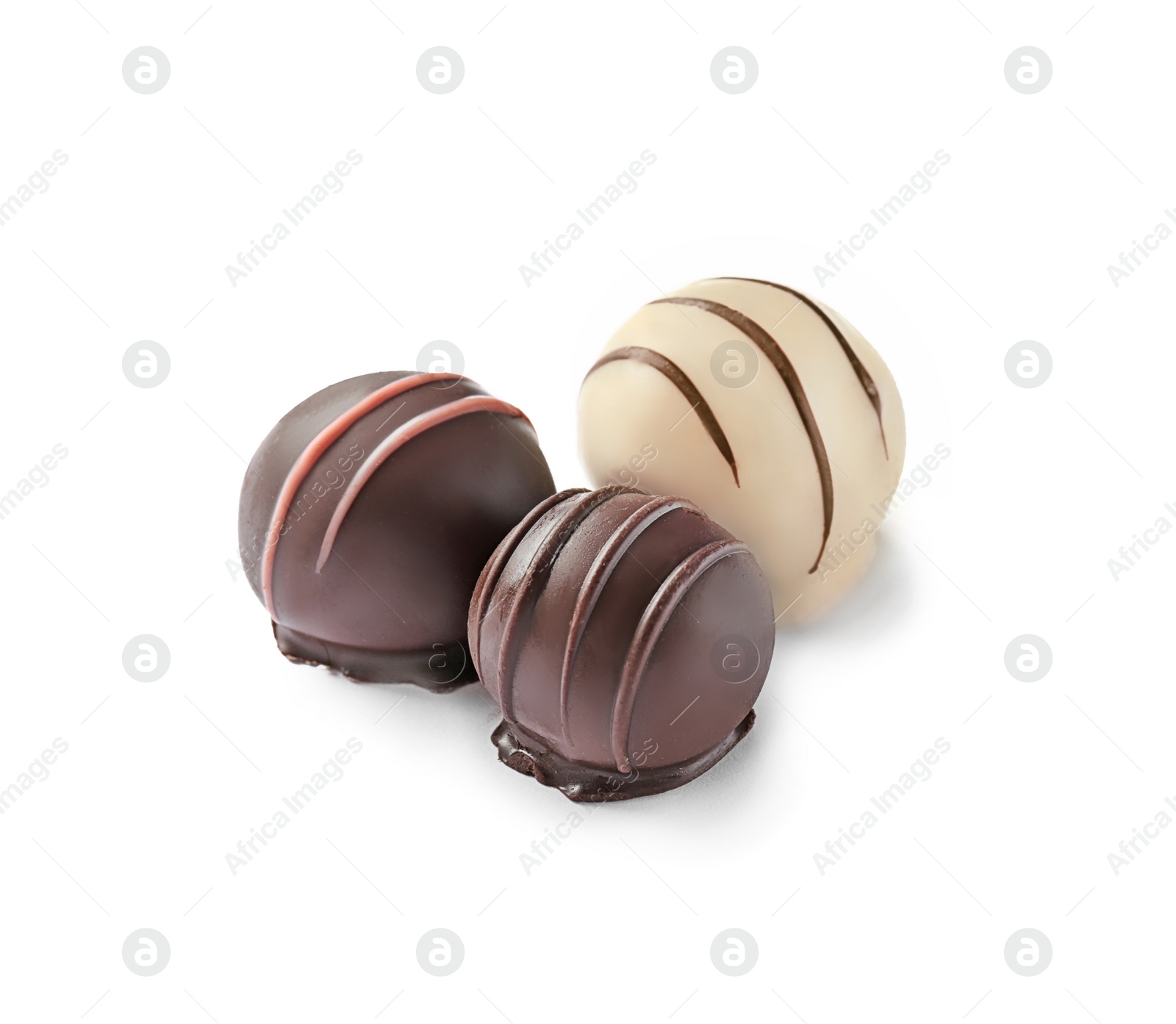 Photo of Three delicious chocolate candies on white background
