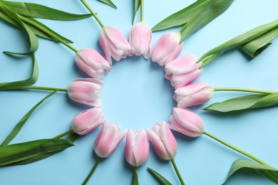 Photo of Beautiful frame made of tulips for Mother's Day on color background