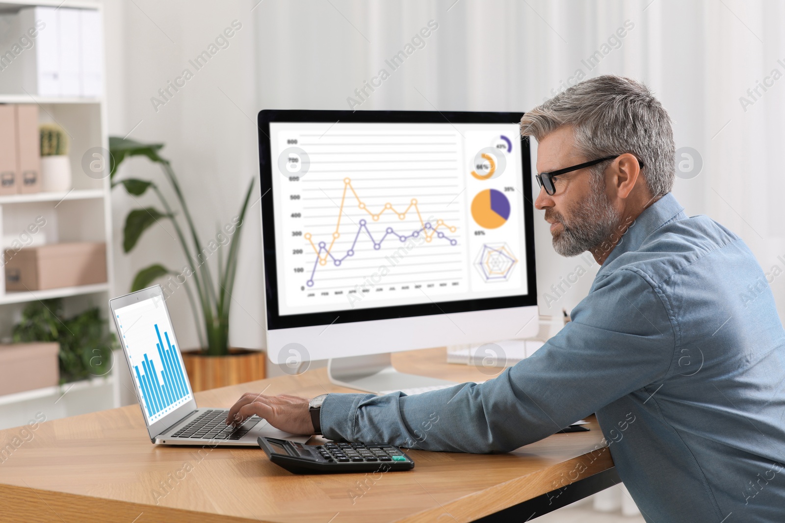 Photo of Professional accountant working at wooden desk in office