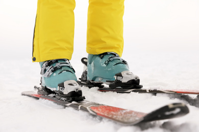 Photo of Young woman skiing on snowy hill, closeup. Winter vacation