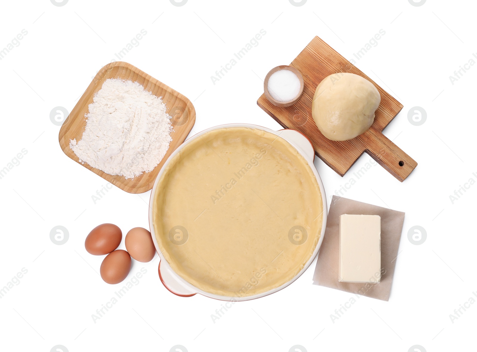 Photo of Pie tin with fresh dough and ingredients isolated on white, top view. Making quiche