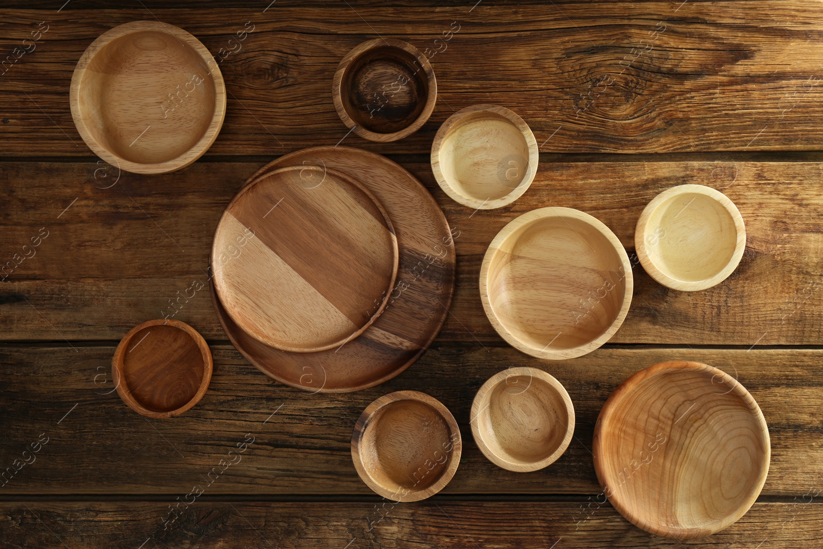 Photo of Set of wooden dishware on table, flat lay