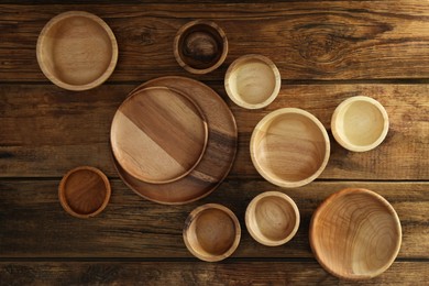 Photo of Set of wooden dishware on table, flat lay