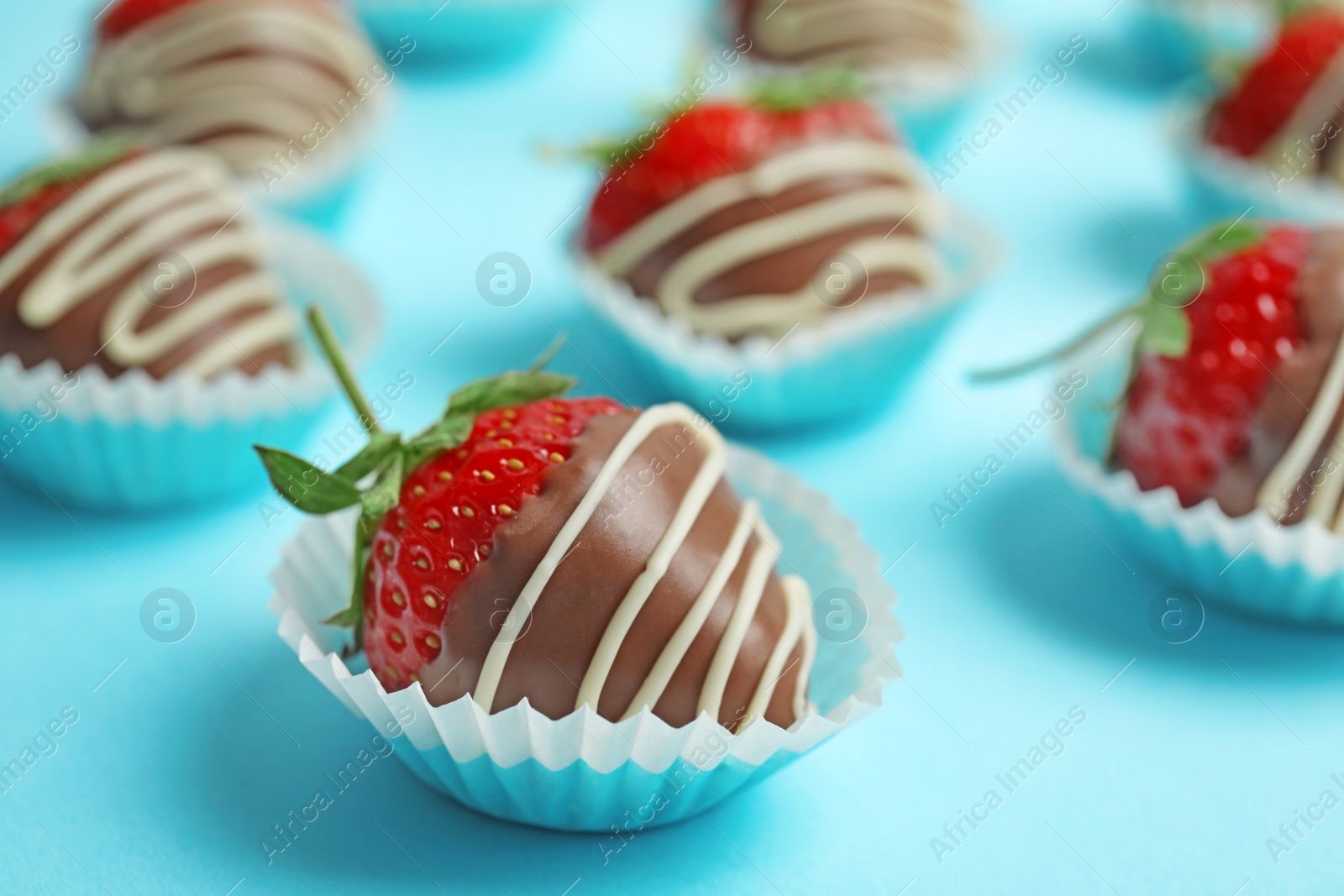 Photo of Delicious chocolate covered strawberries on color background, closeup