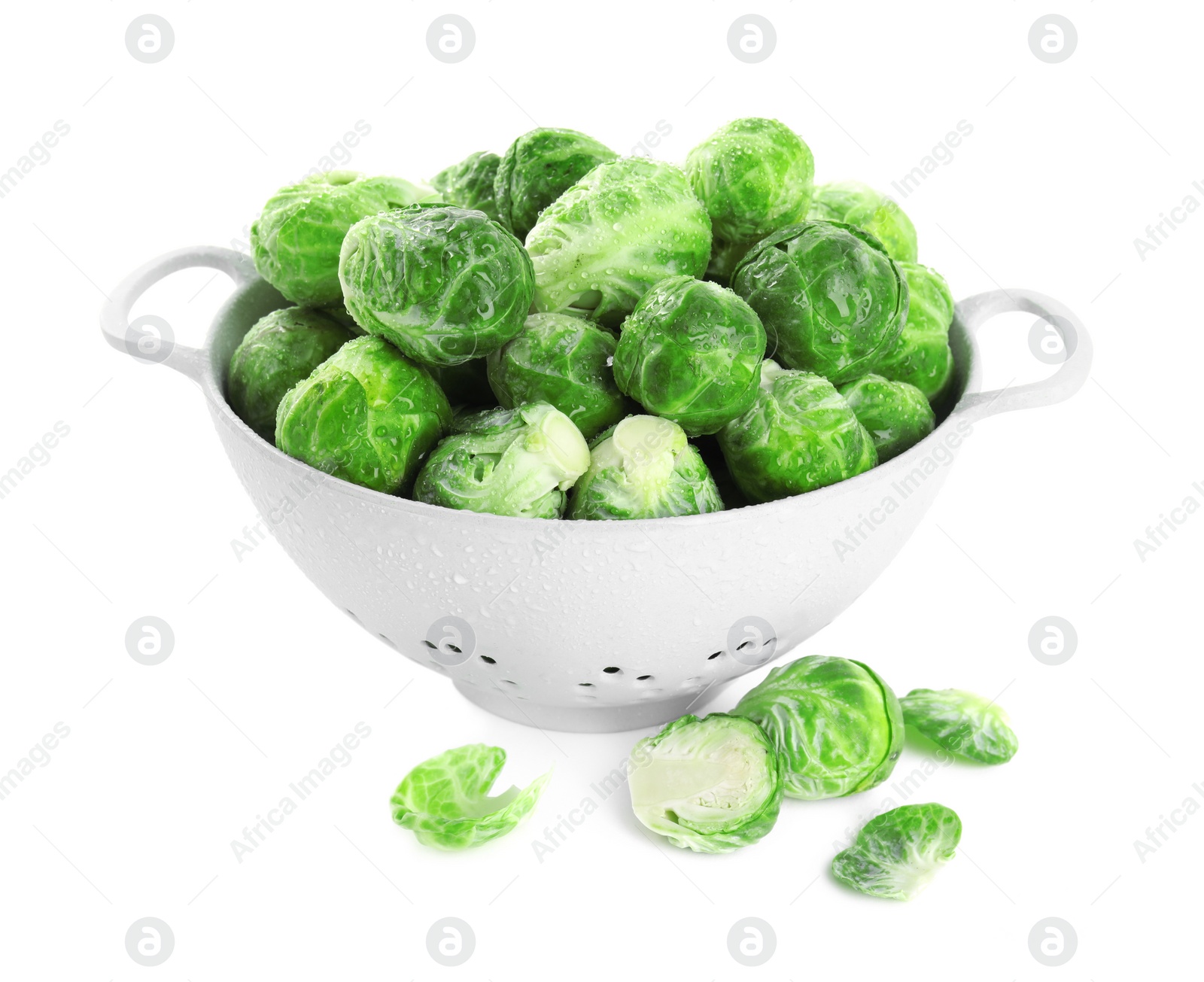 Photo of Fresh Brussels sprouts in colander on white background