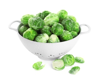 Fresh Brussels sprouts in colander on white background