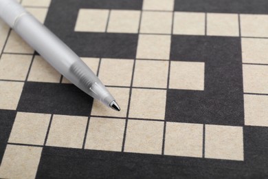 Pen on blank crossword, closeup. Space for text