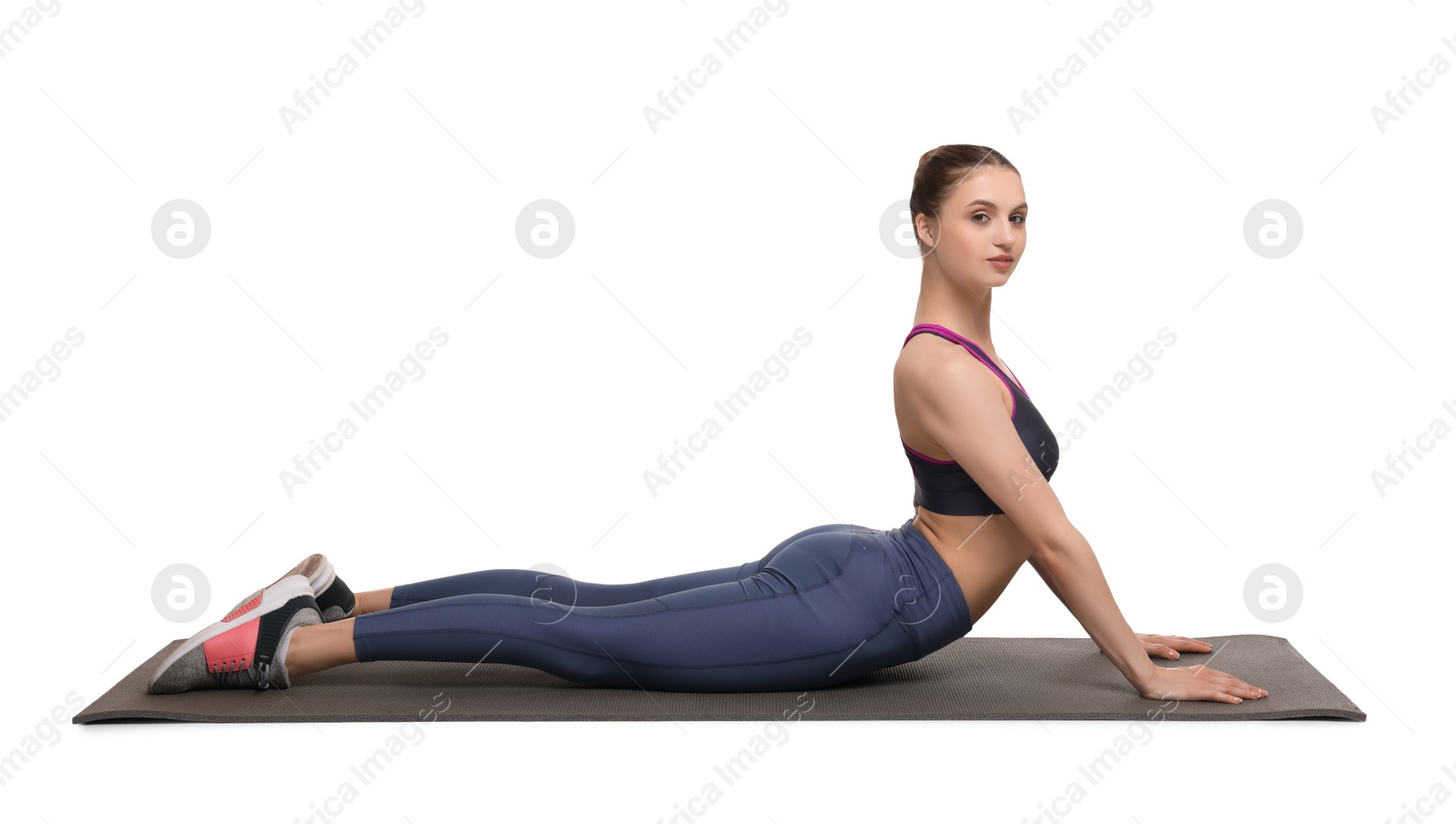 Photo of Young woman practicing yoga on white background