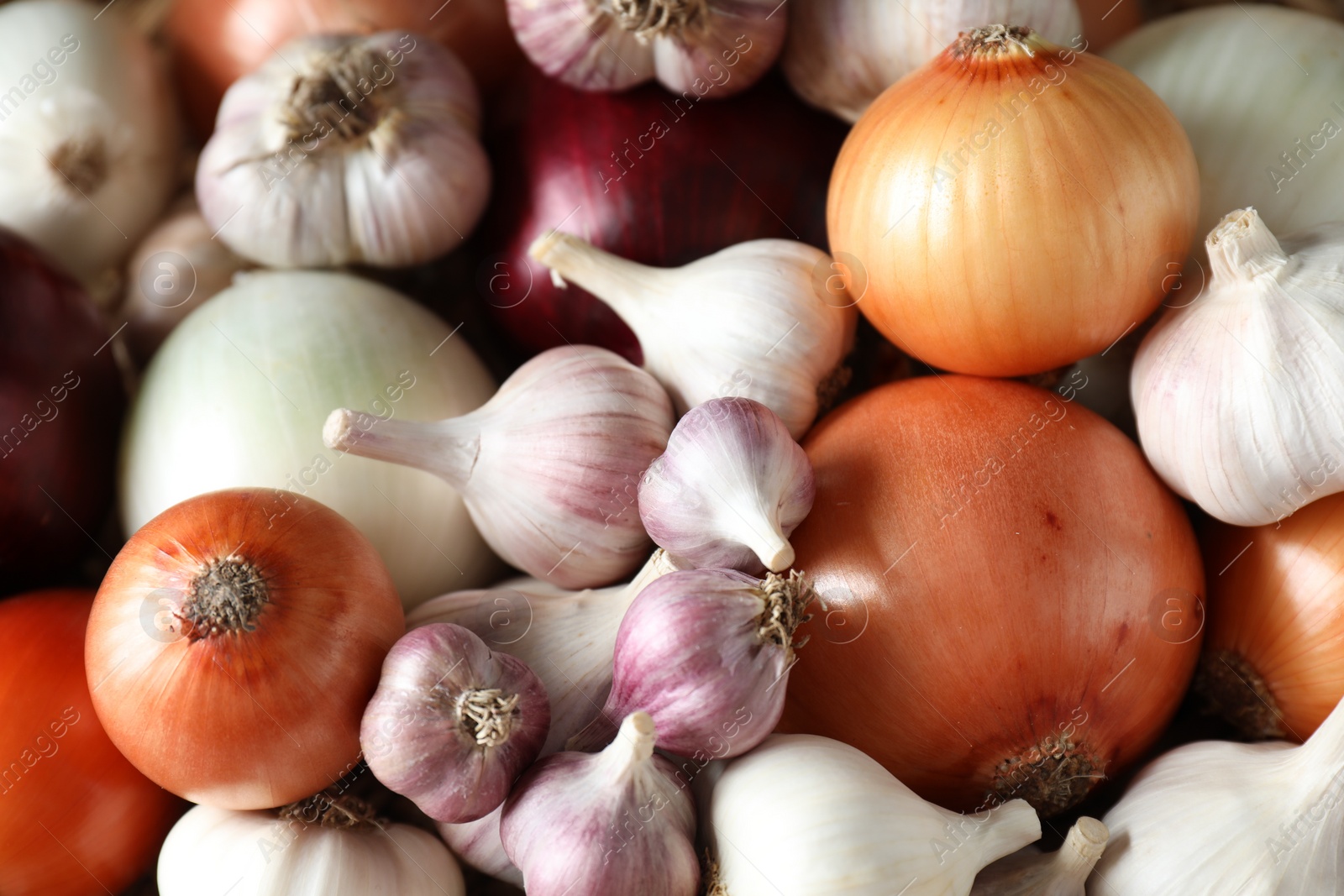 Photo of Fresh raw garlic and onions as background, top view
