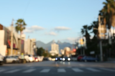 Photo of Blurred view of cityscape with cars on road. Bokeh effect