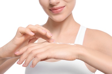 Photo of Young woman applying body cream on white background