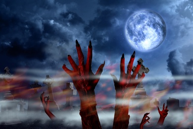 Scary monsters arising from graves at old misty cemetery under full moon on Halloween night
