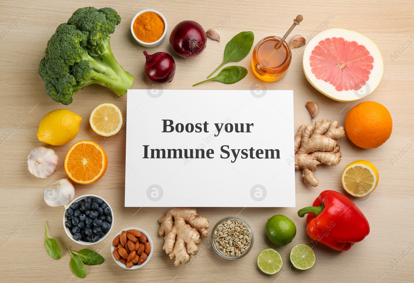 Photo of Card with phrase Boost Your Immune System and fresh products on wooden table, flat lay