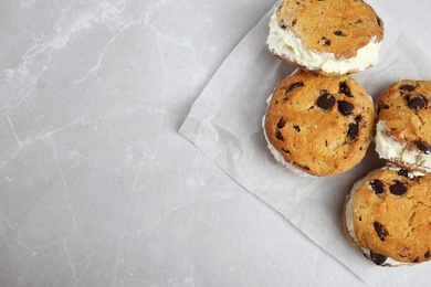 Photo of Sweet delicious ice cream cookie sandwiches on table, top view. Space for text