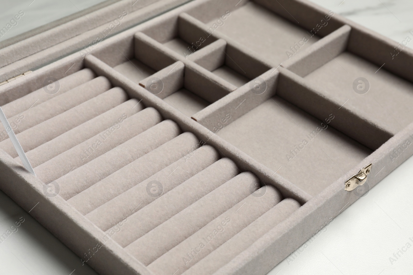 Photo of Empty light grey jewelry box on white table, closeup