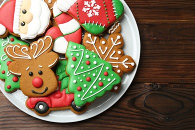 Photo of Different tasty Christmas cookies on wooden table, top view. Space for text
