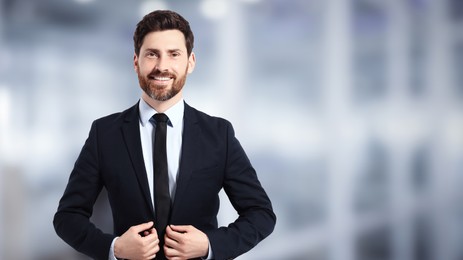Handsome real estate agent in office, space for text