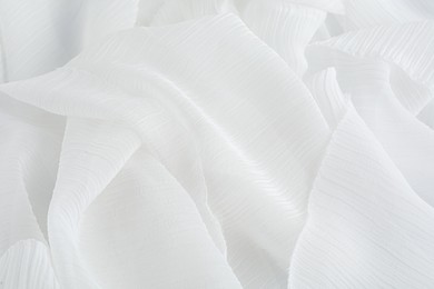 Beautiful white tulle fabric as background, closeup