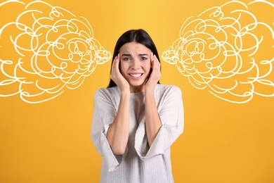 Image of Stressed and upset young woman on yellow background