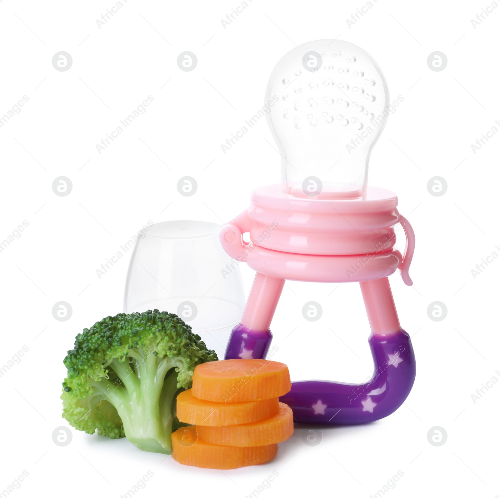 Photo of Empty nibbler with boiled broccoli and cut carrot on white background. Baby feeder