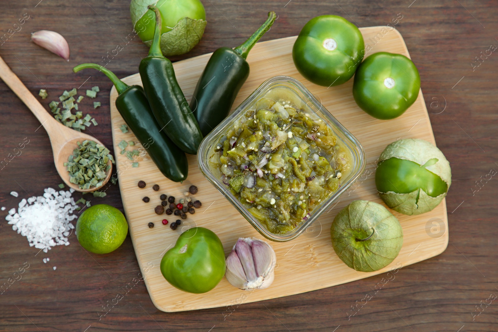 Photo of Tasty salsa sauce and ingredients on wooden table, flat lay