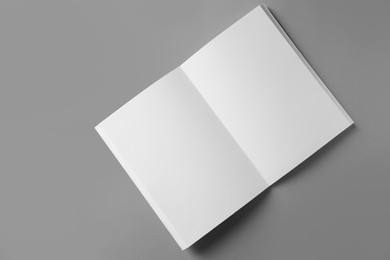 Photo of Open blank brochure on grey background, top view. Mockup for design