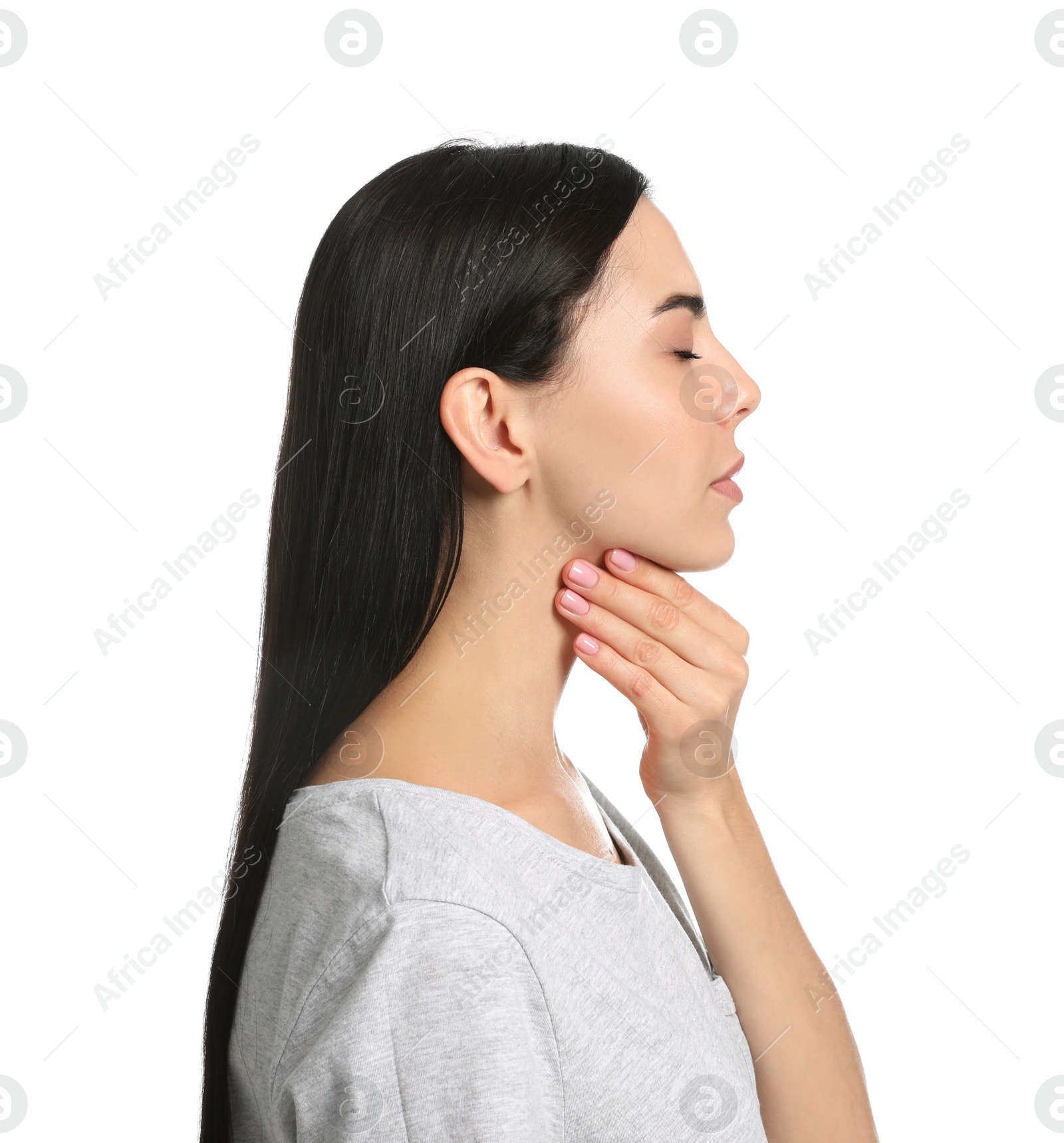 Photo of Young woman doing thyroid self examination on white background