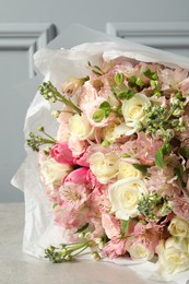 Photo of Beautiful bouquet of fresh flowers on grey table