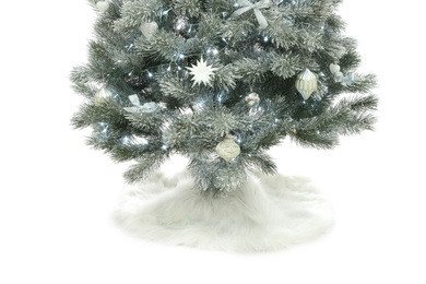 Photo of Decorated Christmas tree with faux fur skirt isolated on white