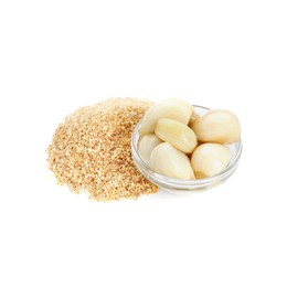 Photo of Heap of dehydrated garlic granules and peeled cloves isolated on white