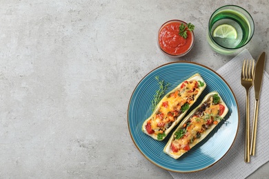 Photo of Flat lay composition with delicious stuffed zucchini on light grey table. Space for text