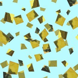 Image of Shiny golden confetti falling on light blue background