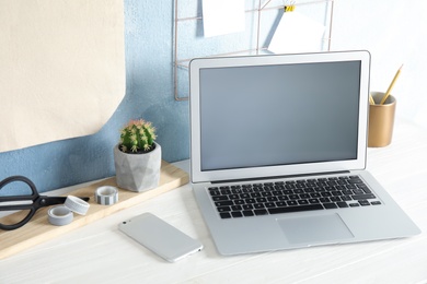 Photo of Cozy blogger workplace with laptop at home
