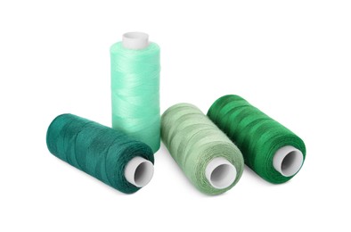 Photo of Different colorful sewing threads on white background
