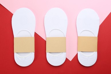 Photo of Soft cotton socks on color background, flat lay