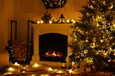 Photo of Beautiful living room interior with burning fireplace and Christmas tree in evening