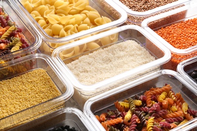 Photo of Many boxes with different raw food, closeup