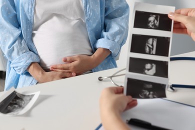 Photo of Pregnant woman having doctor appointment in hospital, closeup