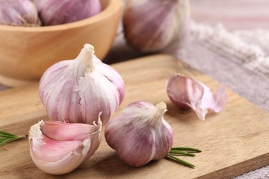 Photo of Bulbs and cloves of fresh garlic on table, closeup