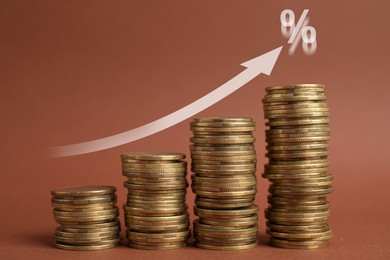 Image of Mortgage rate. Stacked coins, arrow and percent sign on brown background