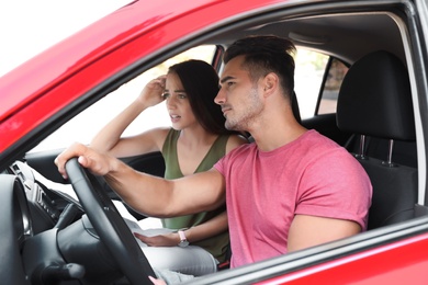 Photo of Young couple with map in car on road trip
