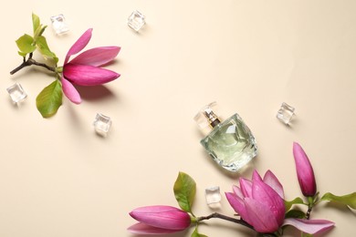 Photo of Beautiful pink magnolia flowers, bottle of perfume and ice cubes on beige background, flat lay