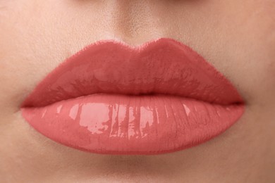 Photo of Woman wearing beautiful lip gloss, closeup view