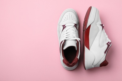 Photo of Pair of stylish shoes on pink background, top view. Space for text