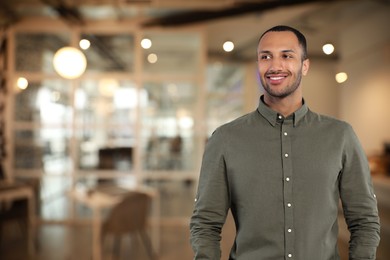 Image of Portrait of handsome confident man in office, space for text