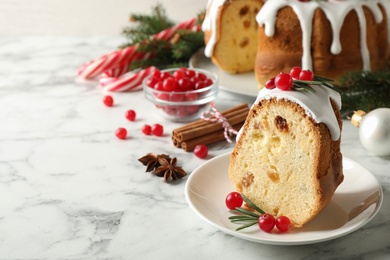 Photo of Composition with piece of traditional homemade Christmas cake on white marble table, closeup. Space for text